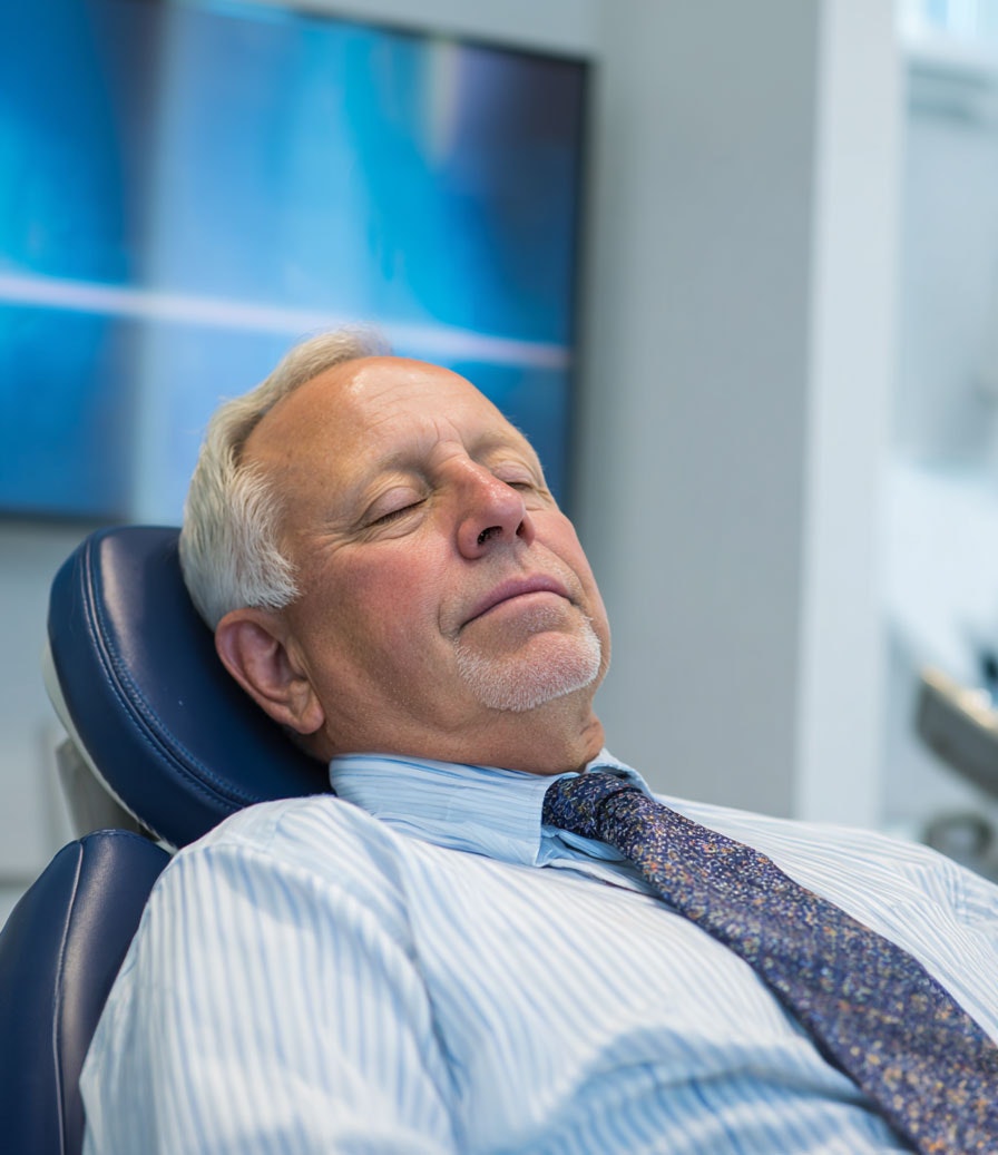 senior man sleeping in dental chair