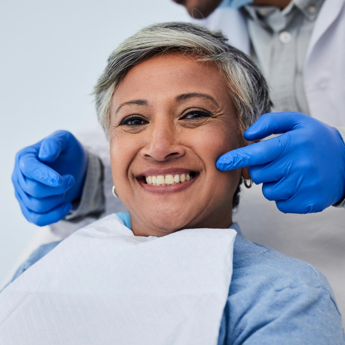 a smiling woman in a dental chair