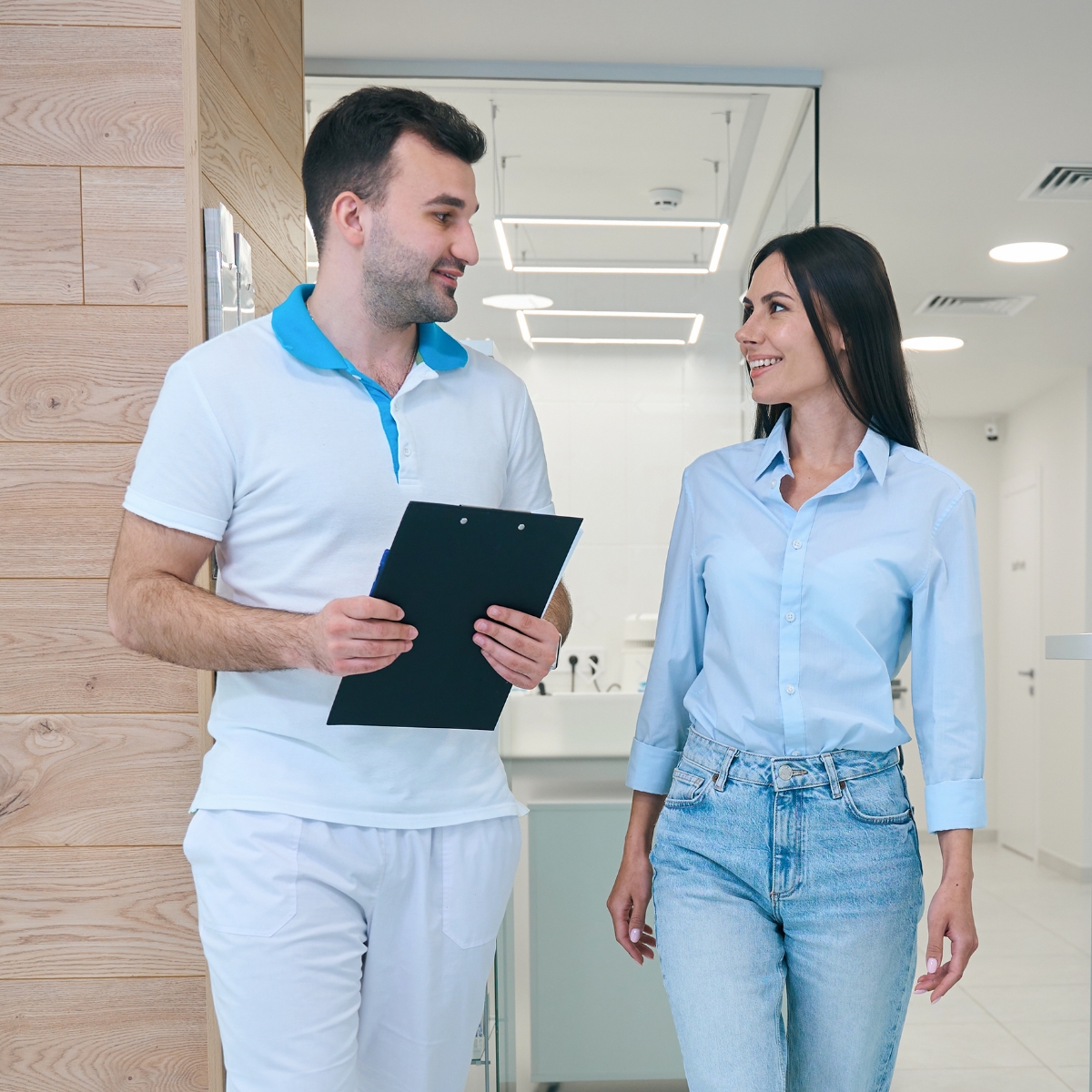 Dental professional and patient talking while walking
