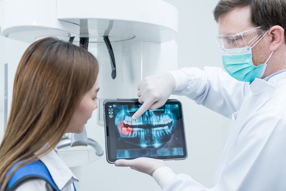 Dentist showing patient digital scans