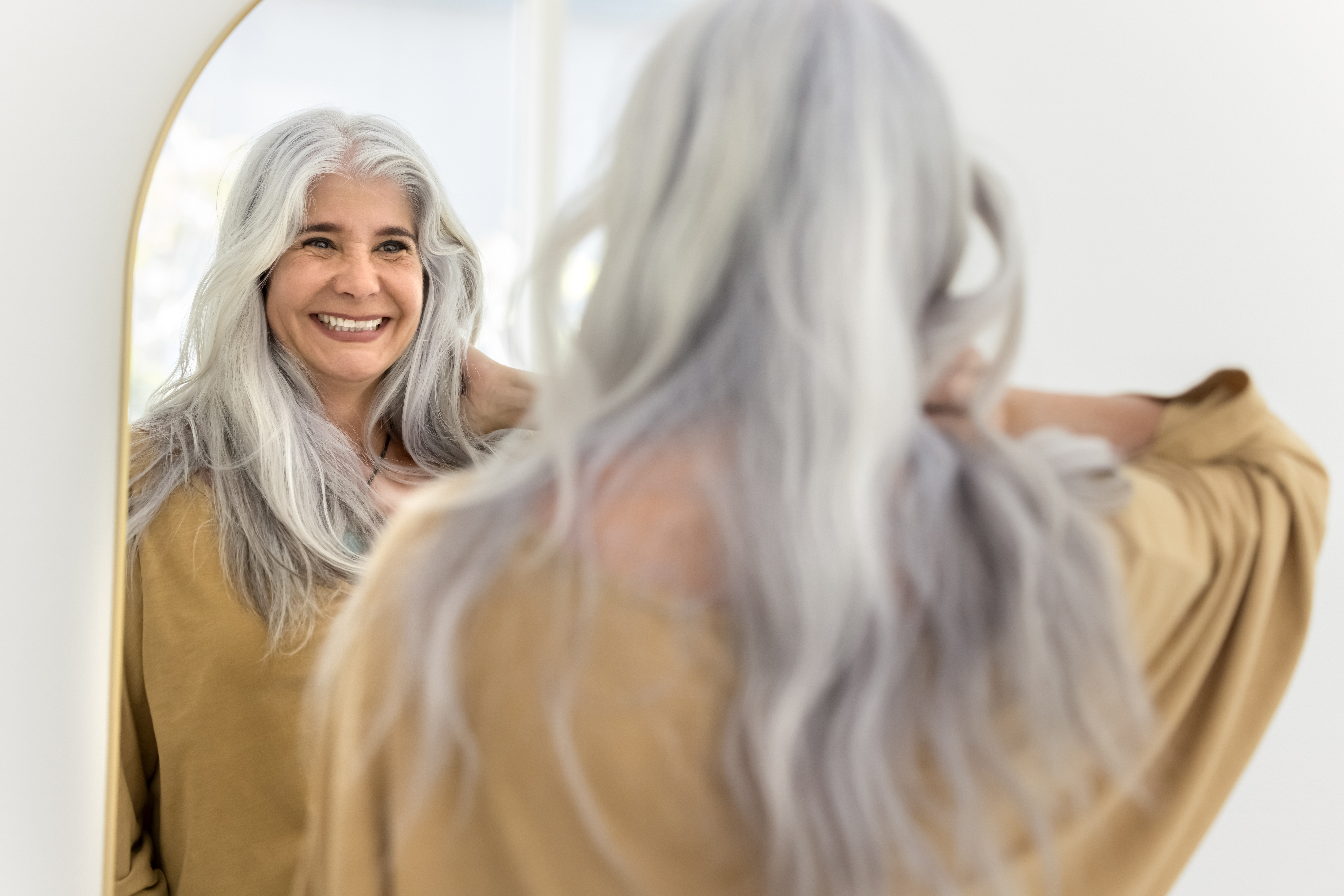 woman smiling in the mirror