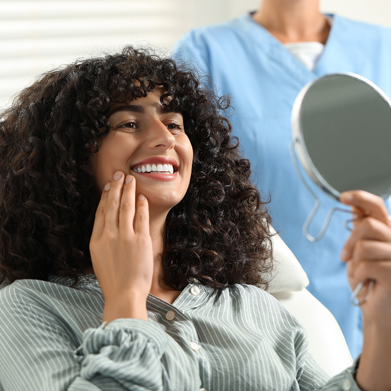 Person smiling into mirror