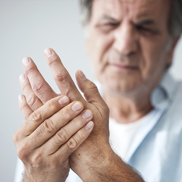 man holding painful hand