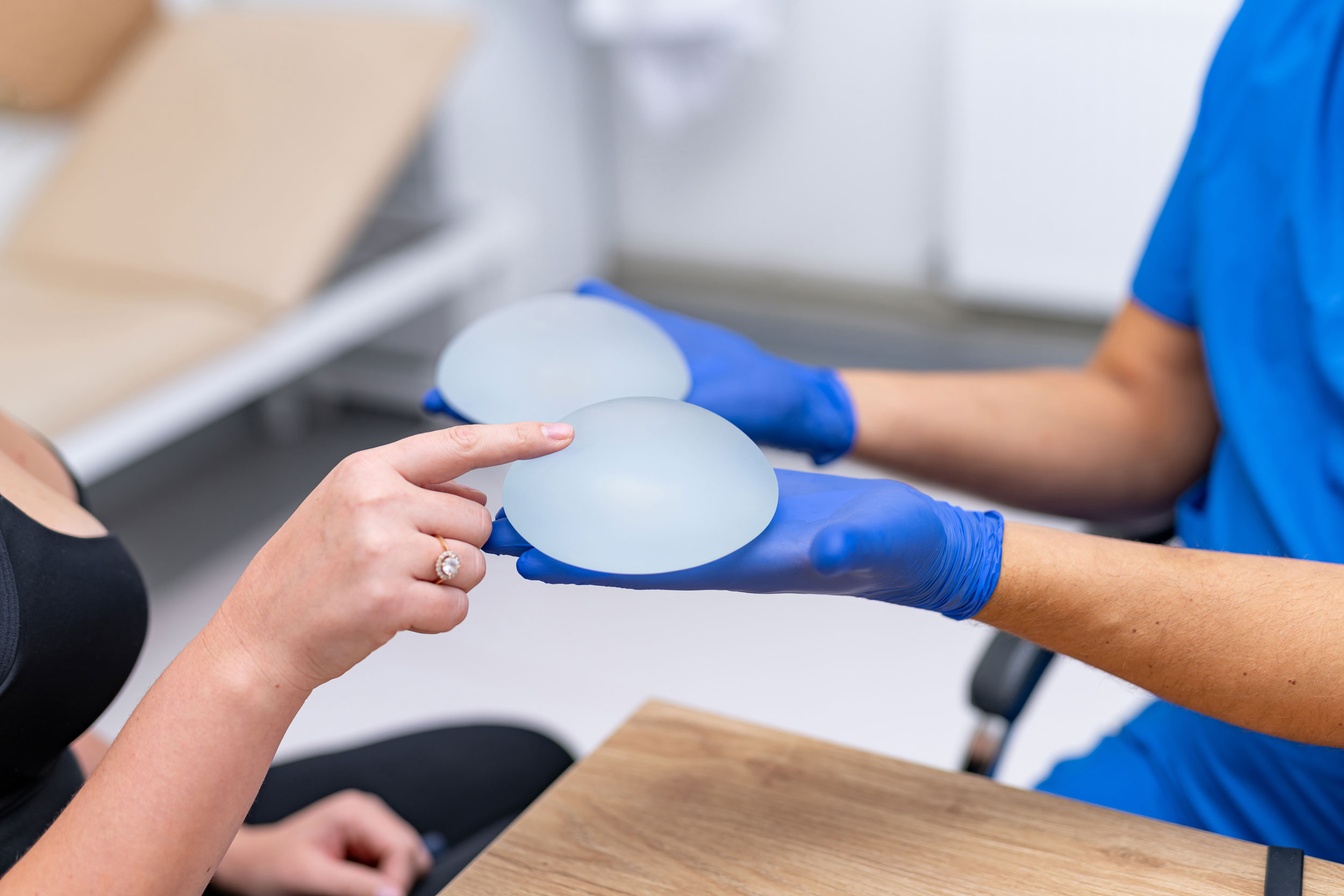 Woman touching breast implants