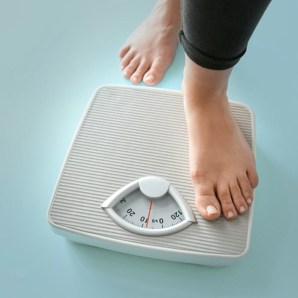 person standing on a weight scale