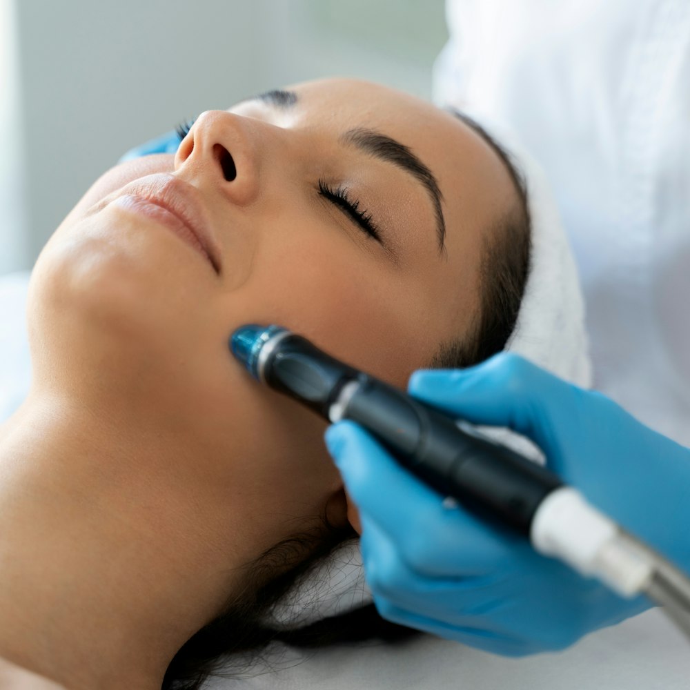 Woman receiving facial treatment