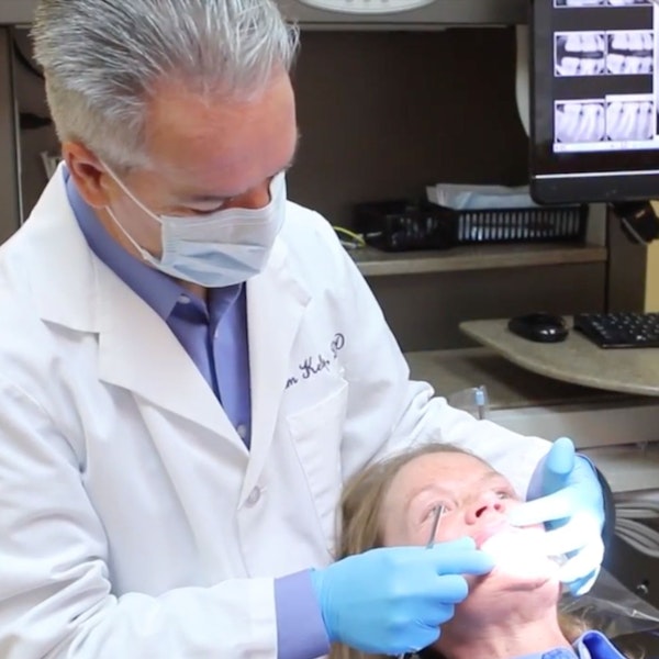 Dr. Kelly evaluating patient's teeth