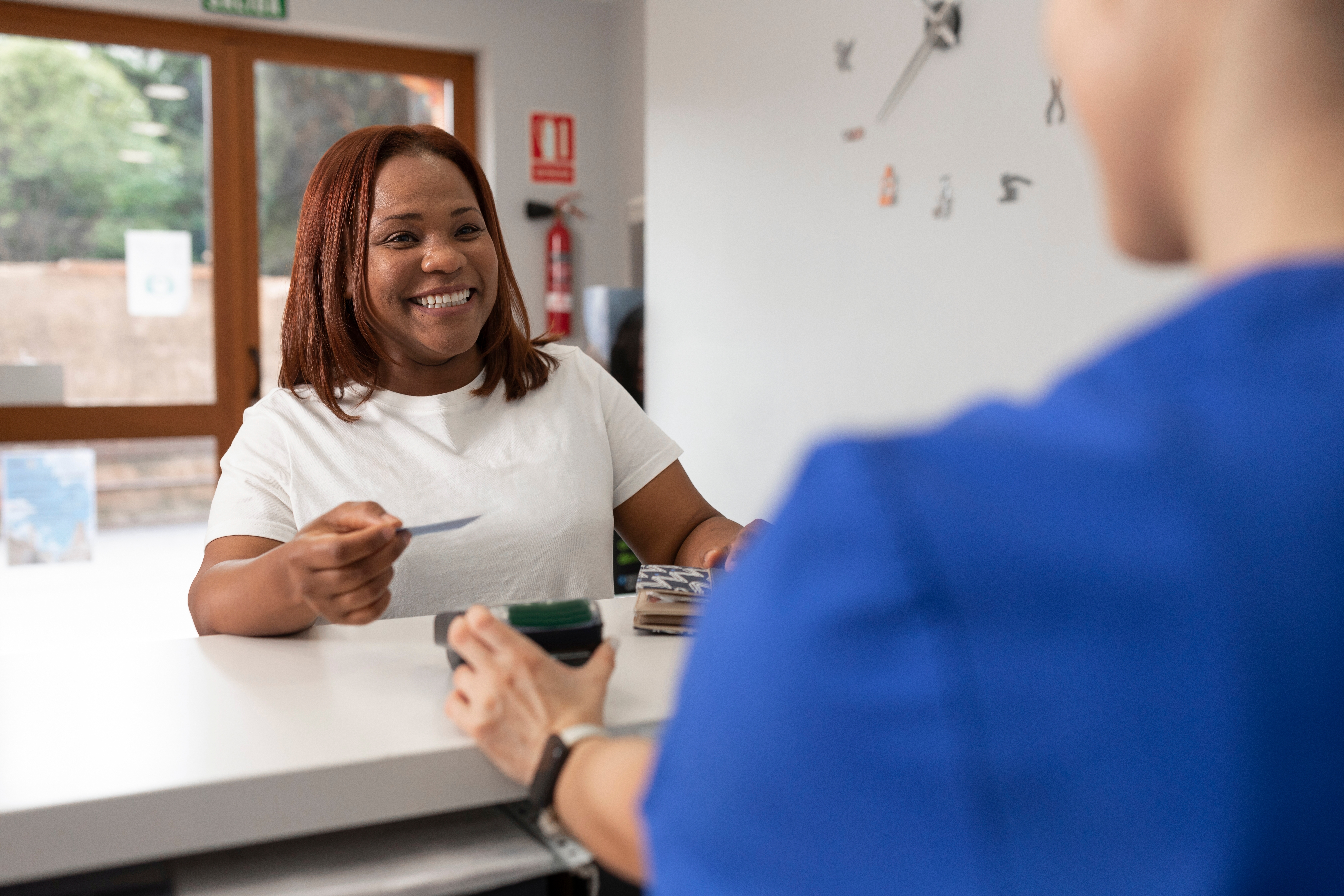 a woman paying the dentist
