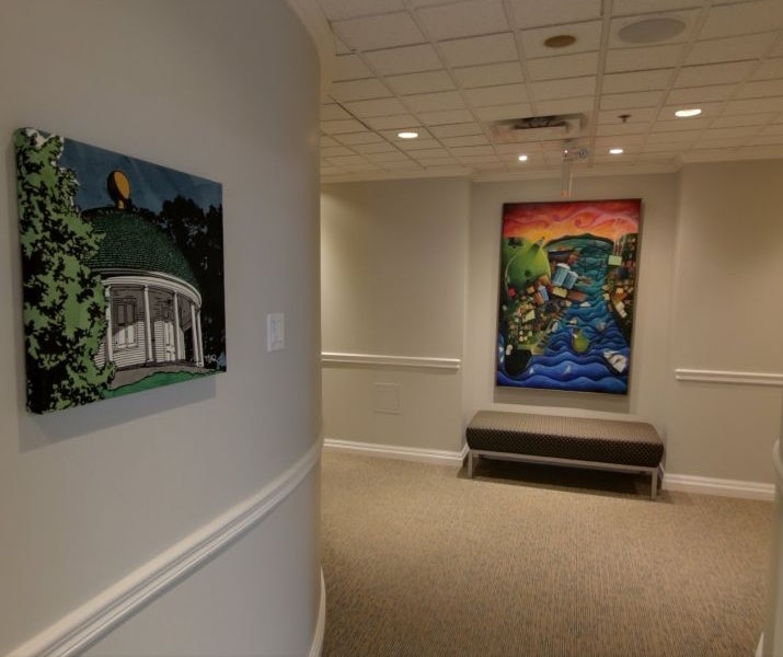 Landing surgery hallway with two paintings and seating area