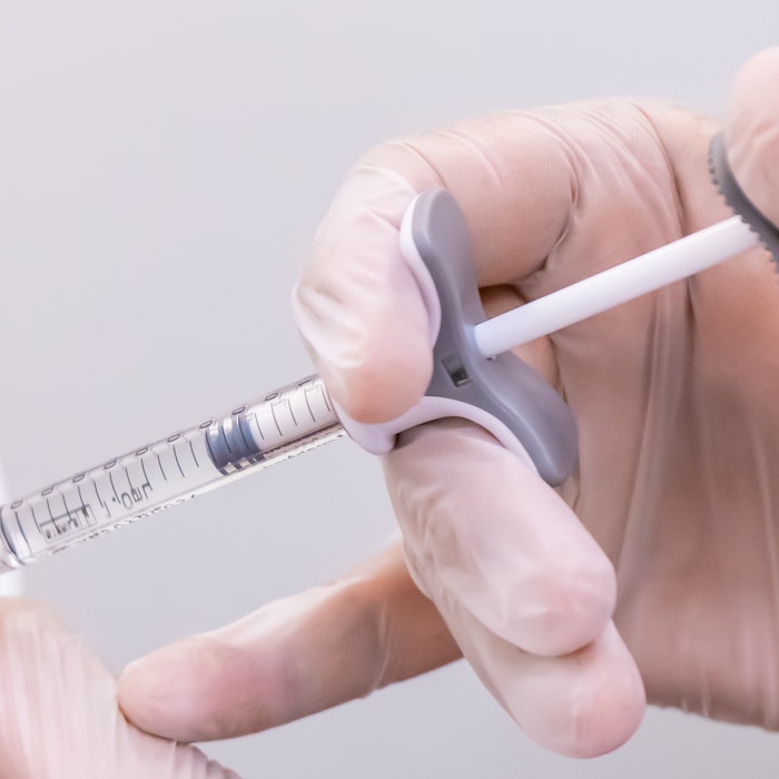 doctor with a syringe of dermal filler