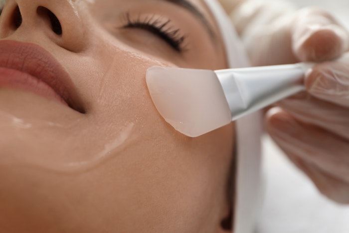 aesthetician applying a skin care product on a client