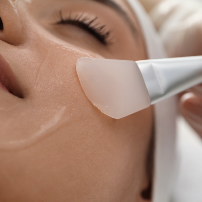 aesthetician applying a skin care product on a client