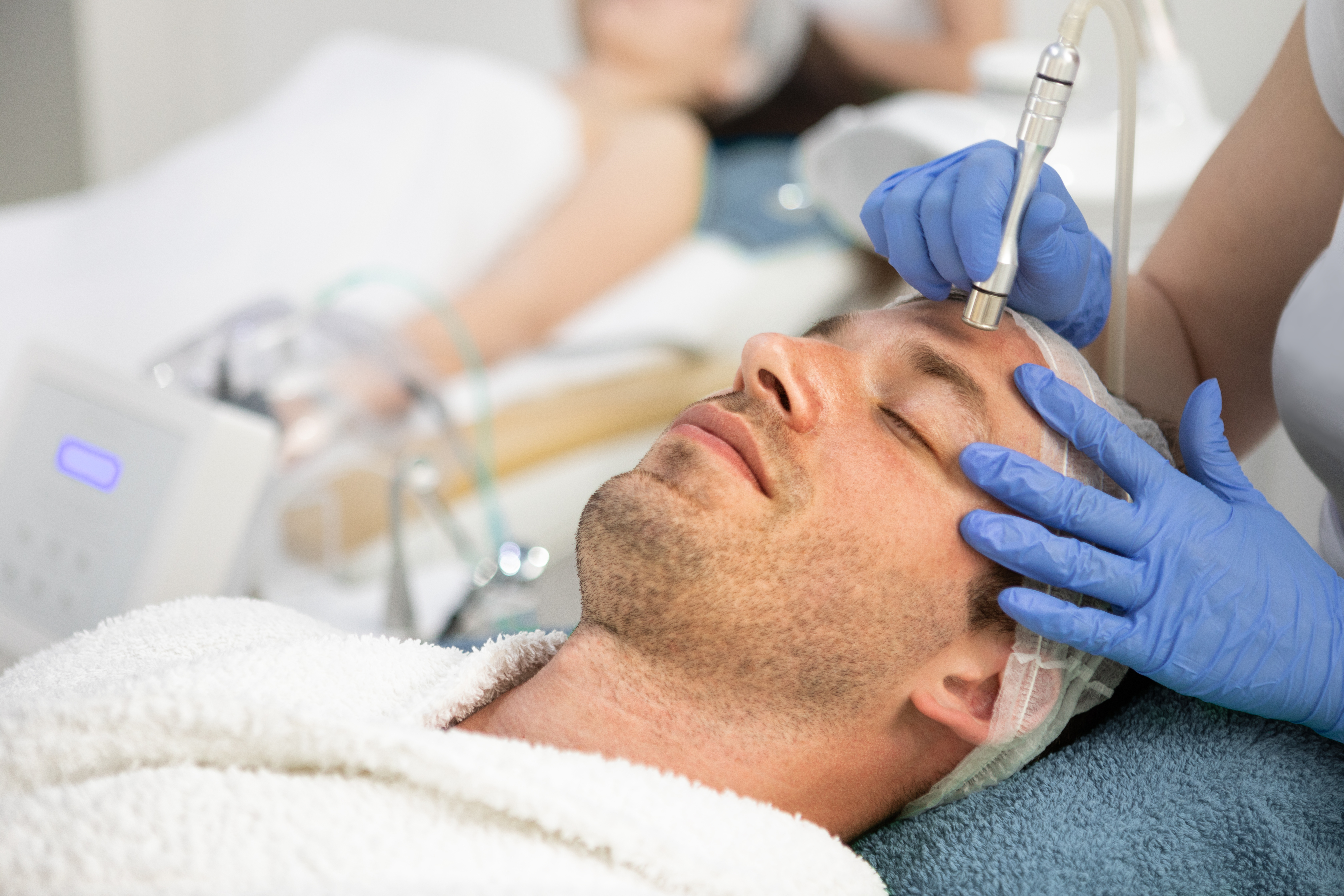 man undergoing a dermabrasion treatment