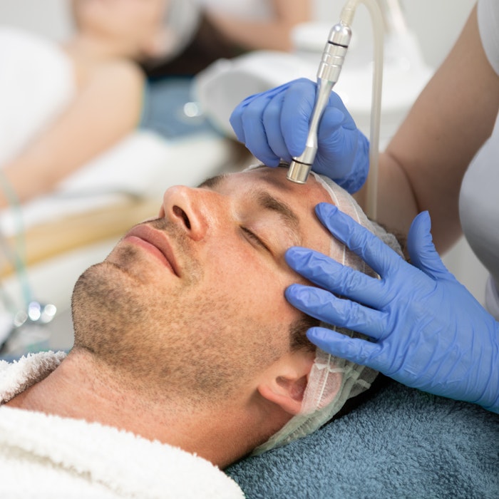 man undergoing a dermabrasion treatment