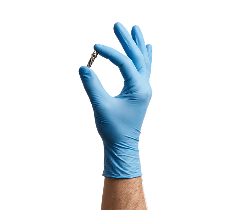 man in blue medical gloves holding metal dental implant in his right hand