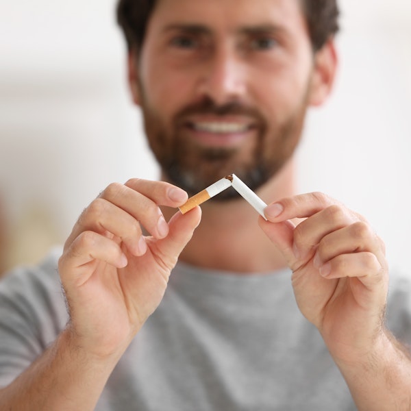 Man breaking cigarette