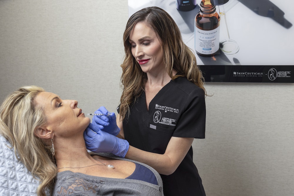 Woman receiving an injection in her face