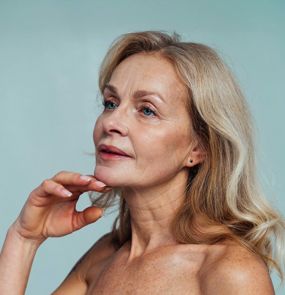mature woman touching chin