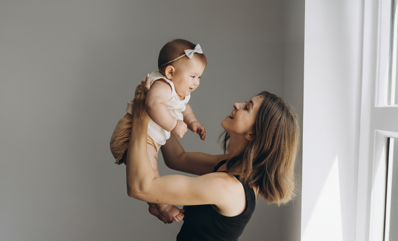 mother lifting her baby