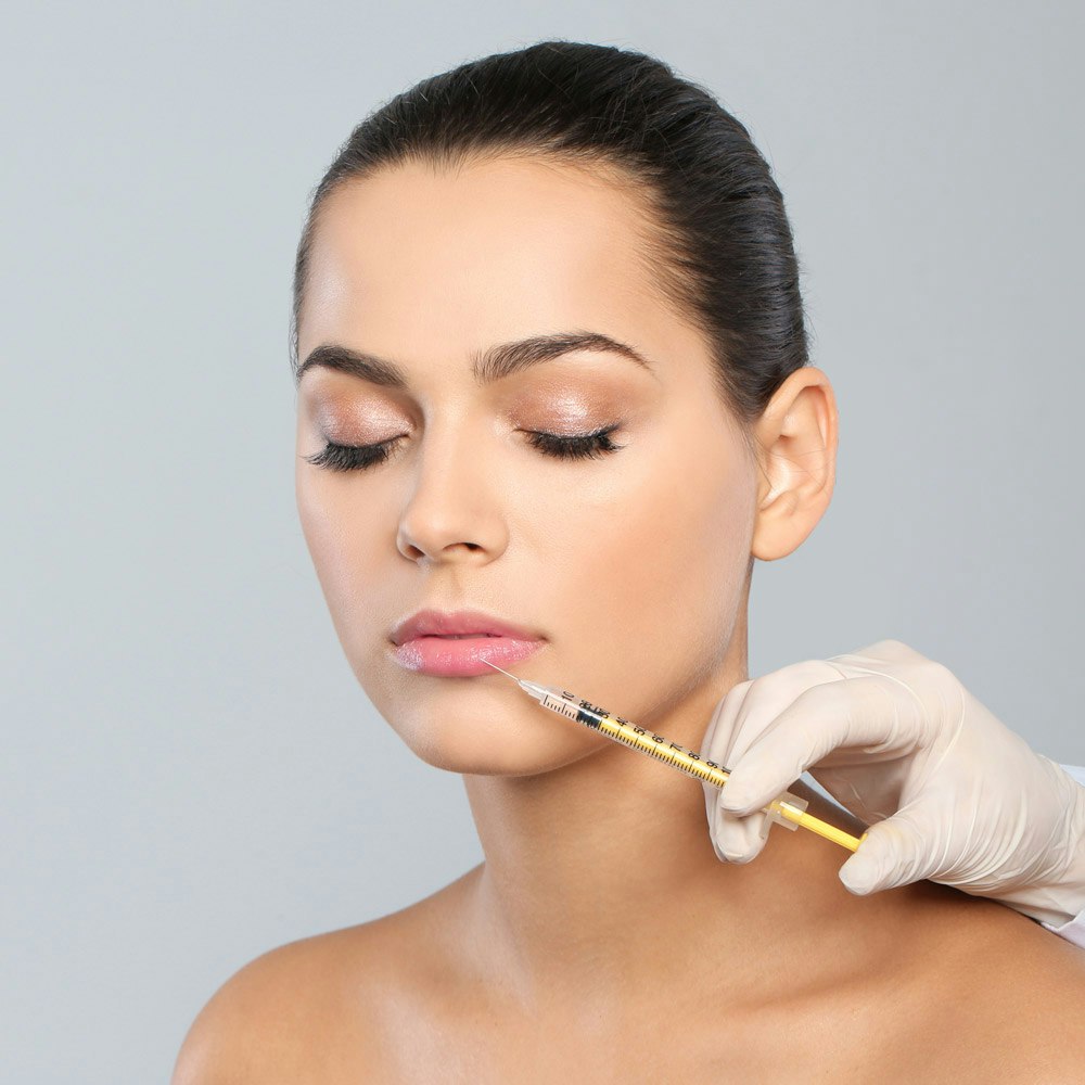 Woman receiving cosmetic facial injection