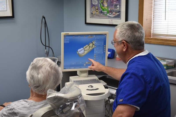 Dentist and patient looking at x-ray