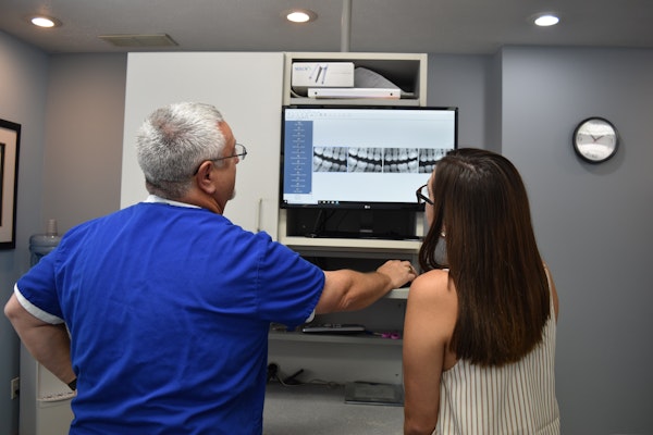 Dr. Lande and patient looking at dental x-rays