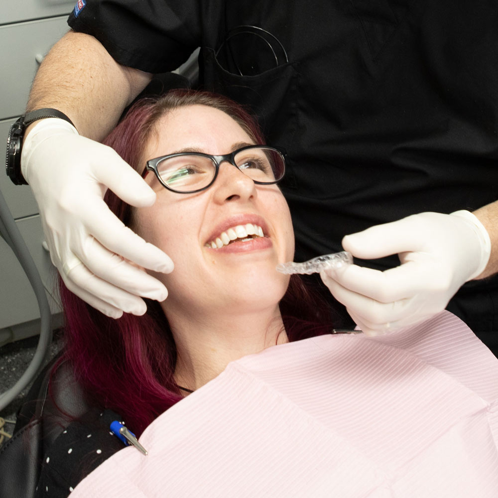 Dr. Lande placing an Invisalign on a patient