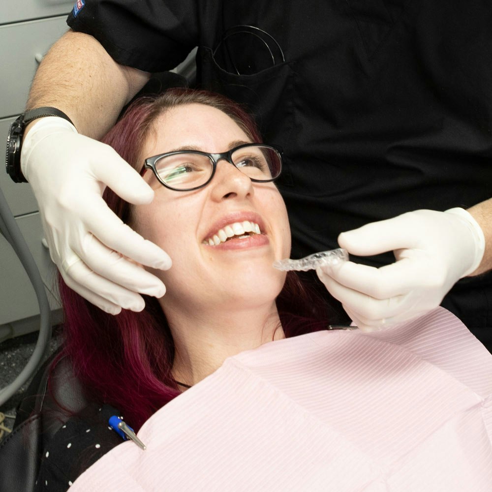 Dr. Lande placing an Invisalign on a patient