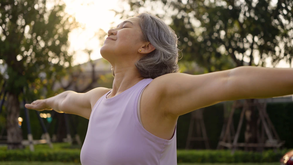 woman smiling with arms open