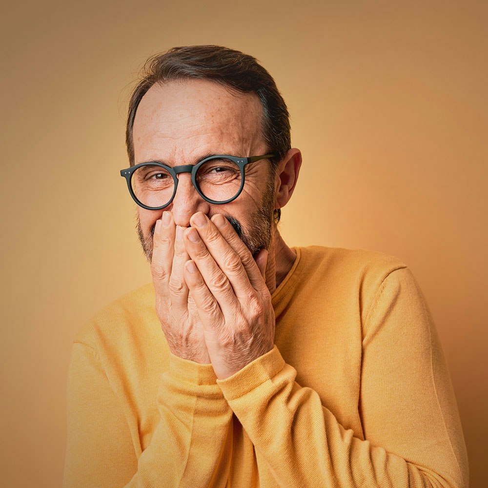 Man in glasses laughing