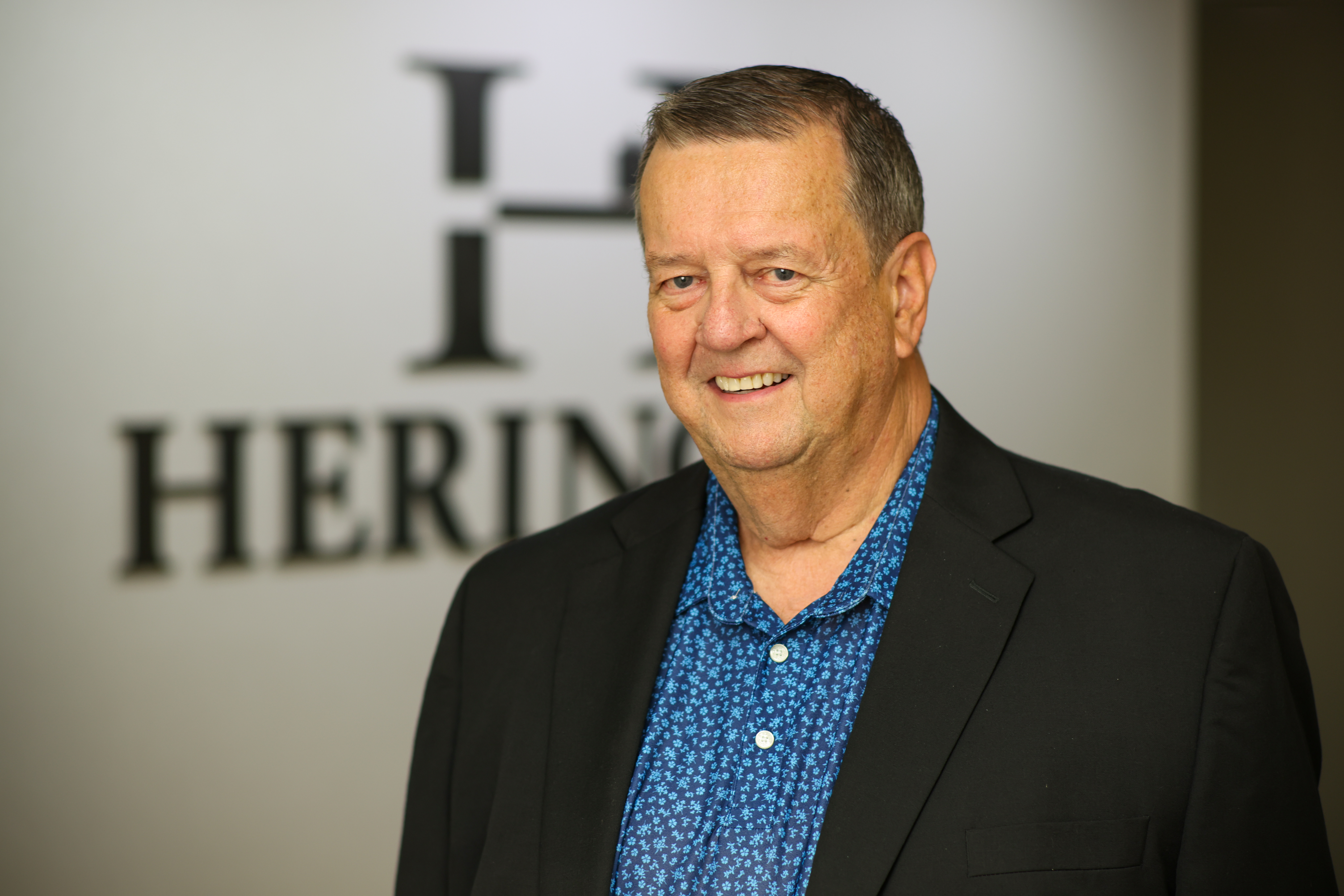 Dr. Heringer in front of practice logo