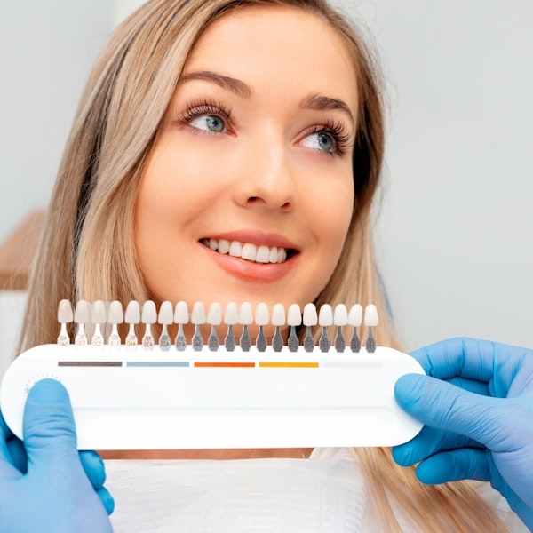 Woman comparing different veneer shades