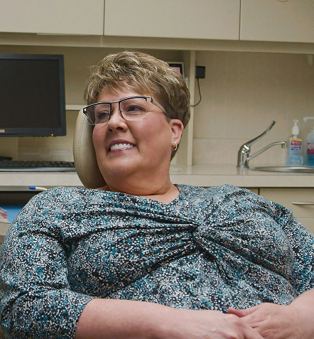 smiling woman in dentist's chair