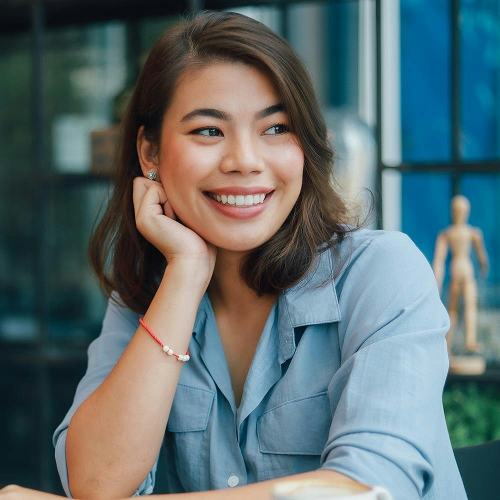 Smiling woman resting hand on chin