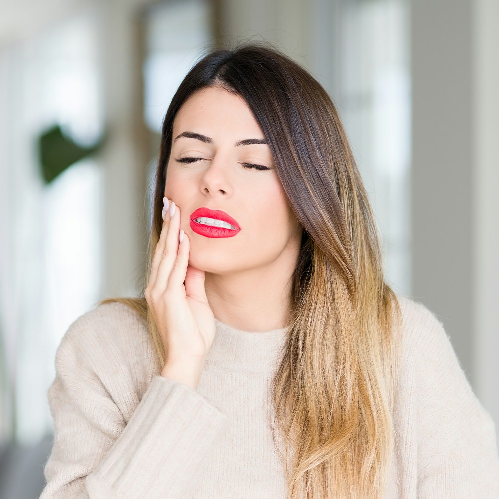 woman with sore tooth