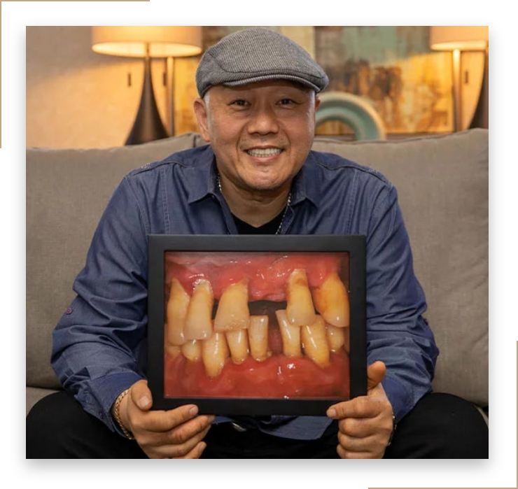 man smiling while holding his "before" picture