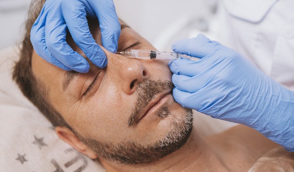 Man receiving liquid rhinoplasty