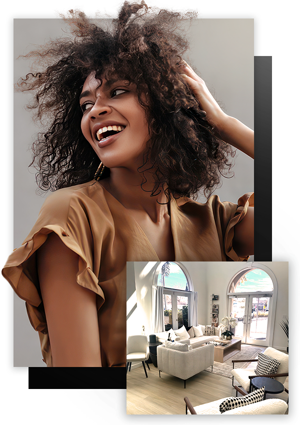 bron-skinned woman with curly hair smiling. interior image of office lobby