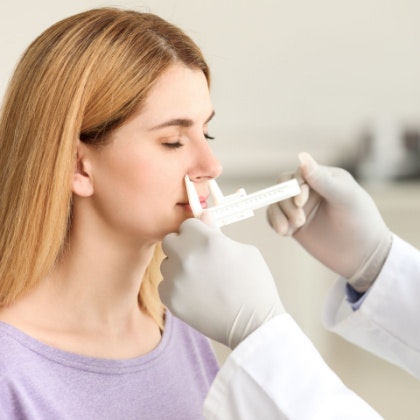 Woman getting her nose measured