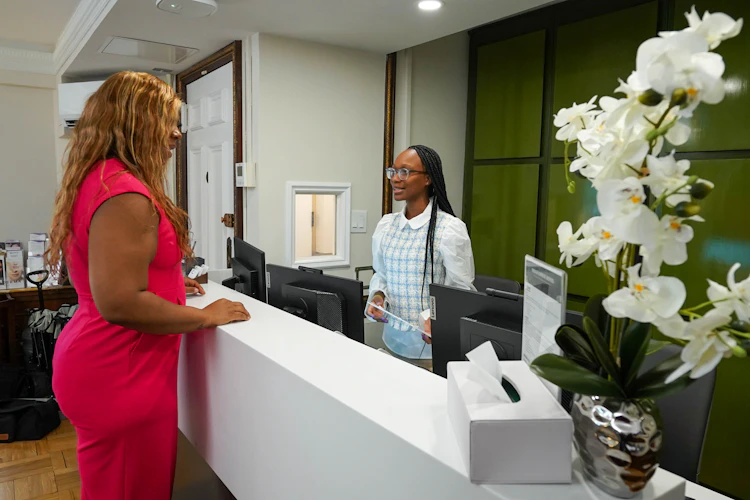 Patient talking to receptionist