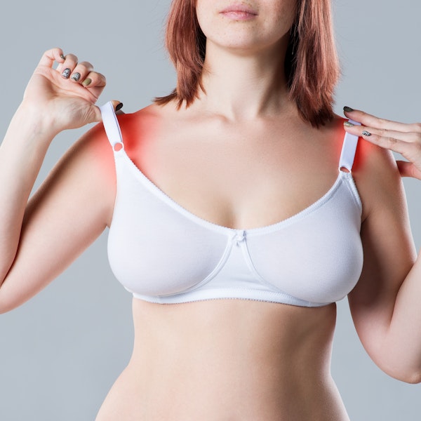 woman experiencing shoulder pain from bra straps