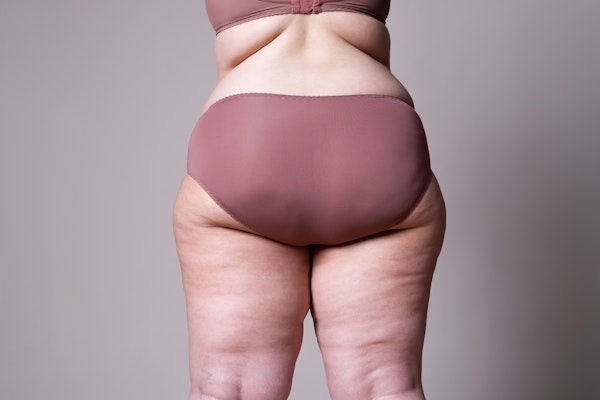 woman's posterior in maroon underwear with cellulite