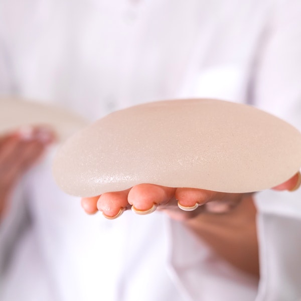 Person holding silicone breast implant