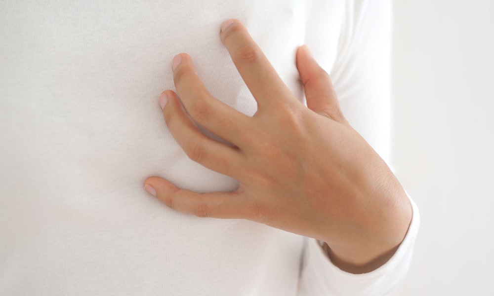Woman touching breast after reconstruction