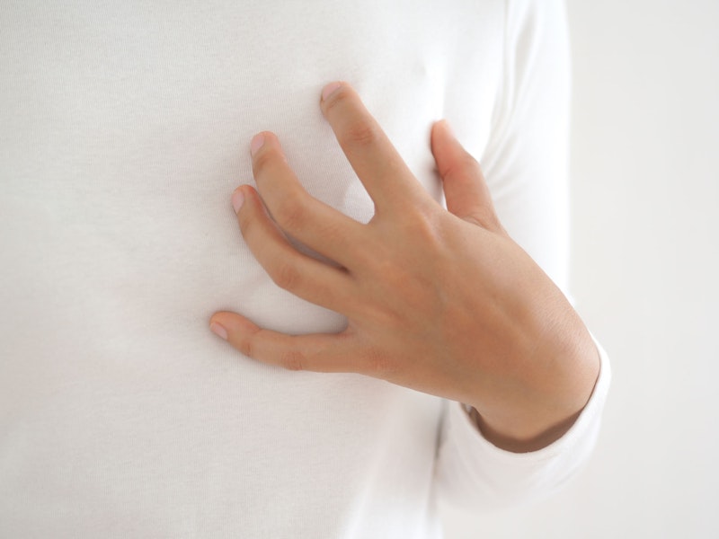 Woman touching breast after reconstruction