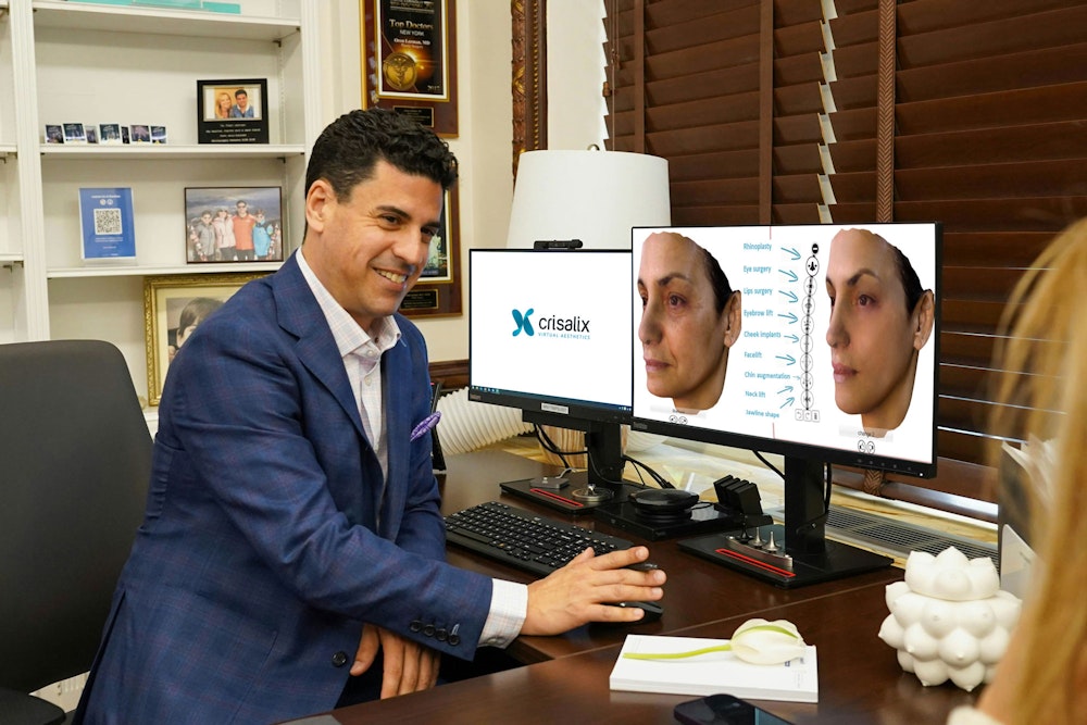 Dr. Oren Lerman seated at desk using Crisalix software during patient consultation