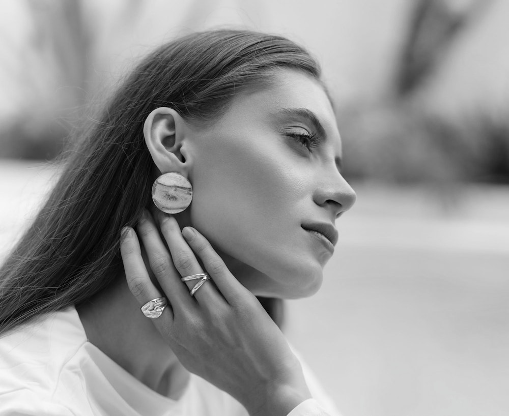 woman's sideprofile of facelift with jewelry on hands