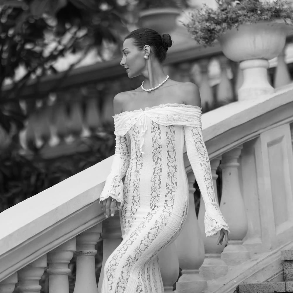 side profile of woman in white lace dress showcasing tummy tuck