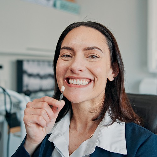 woman holding a dental implant