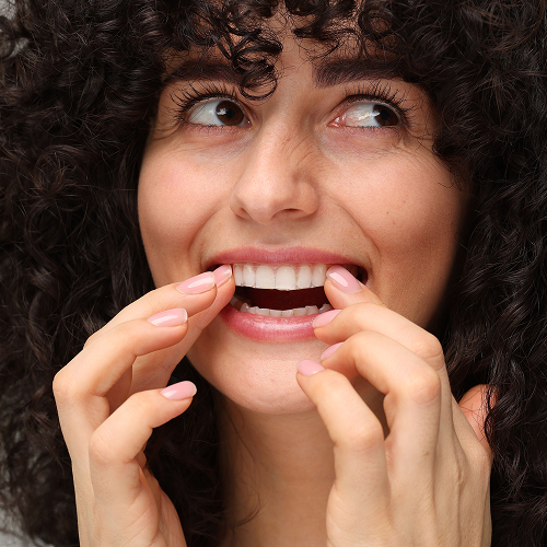 woman putting in invisalign